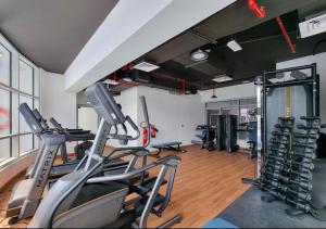 a gym with treadmills and elliptical machines at not active in Dubai