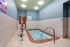 a bathroom with a swimming pool in a room at Holiday Inn Express & Suites Oakland - Airport, an IHG Hotel in Oakland