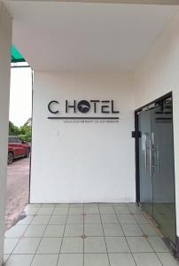 a hotel sign on the side of a building at C Hotel in Jitra
