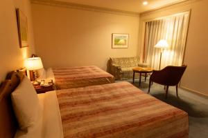 Postel nebo postele na pokoji v ubytování Fuji Classic Hotel