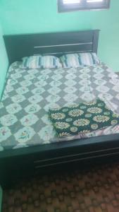a bed with a comforter and a pillow on it at KKA RESIDENCY in Coimbatore