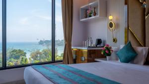 a hotel room with a bed and a large window at Hotel Atlanta - A Seaview Hotel in Port Blair
