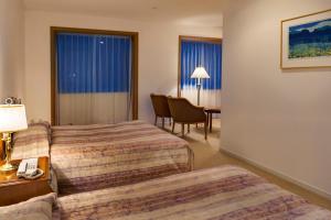 Postel nebo postele na pokoji v ubytování Fuji Classic Hotel