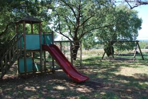 a playground with a slide in a park at Apartment Rama in Poreč