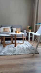 a living room with a couch and a coffee table at Kaunis yksiö lähellä keskustaa in Hyvinkää
