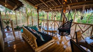 a porch with a hammock and a swing at Carabao Lodge - 2 bedroom house, stargazing & pool in El Nido