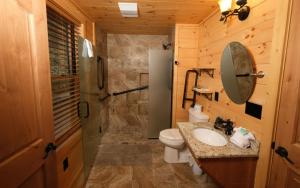a bathroom with a toilet and a sink and a shower at Hot tub and game room! - Black Bear Crossing in Gatlinburg +21 photos