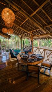 a dining room with a wooden table and chairs at Carabao Lodge - 2 bedroom house, stargazing & pool in El Nido