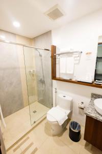 a bathroom with a shower and a toilet and a sink at Cebu Quincentennial Hotel in Cebu City