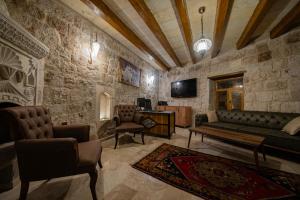 a living room with a couch and a table and chairs at Ares Cave Suites in Goreme