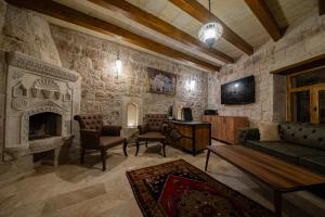 a living room with a stone wall at Ares Cave Suites in Göreme