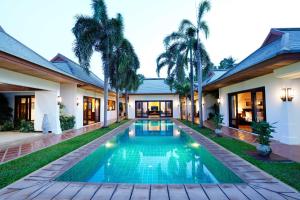 an exterior view of a villa with a swimming pool at Miskawaan Luxury Beachfront Villas in Mae Nam