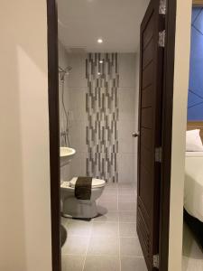 a bathroom with a toilet and a sink at Bless Hotels in Sintang