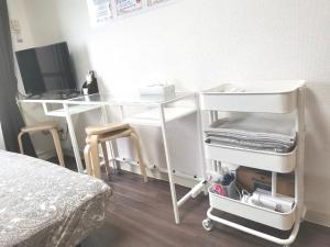 Un pat sau paturi într-o cameră la XL Shinjuku House