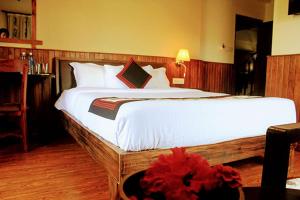 a bedroom with a large bed with a red flower on it at Hotel Yechu in Bhaktapur