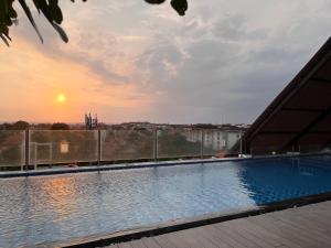 a swimming pool on the roof of a building at Luminor Hotel Legian Seminyak - Bali in Legian