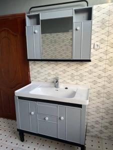 a bathroom with a white sink and a mirror at 2 bedroom apartment in Musanze( Benji) in Ruhengeri