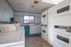a kitchen with white appliances and a window at Moab RV Resort Glamping Tipi OKTP-53 in Moab