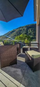a patio with tables and chairs and a view of a mountain at Ferienwohnung - Riesling Ambiente - im Weingut Andries in Ernst