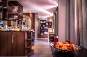 a bowl of fruit on a table in a room at Hôtel Garance in Paris
