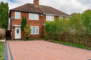 a brick house with a white door and a brick driveway at Private immaculate contractor and leisure stay with large driveway in Birmingham