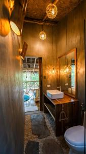 a bathroom with a sink and a mirror at Carabao Lodge - 2 bedroom house, stargazing & pool in El Nido