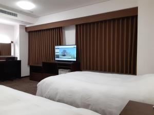 Postel nebo postele na pokoji v ubytování Hotel Alpha-One Matsue + 3 fotografie