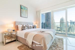 a bedroom with a bed and a large window at Manzil - 2BR in Dubai Marina with Sea and Marina View in Dubai