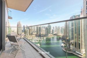 a balcony with a view of a river and buildings at Manzil - 2BR in Dubai Marina with Sea and Marina View in Dubai