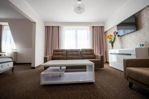 a living room with a couch and a coffee table at Hotel Pałacowa in Narol