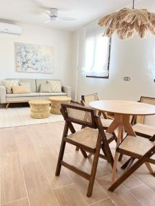 sala de estar con mesa, sillas y sofá en Olcina apartments en El Castell de Guadalest
