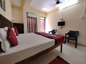 Postel nebo postele na pokoji v ubytování Sanman Hotels