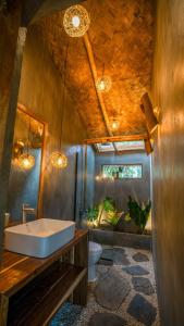 a bathroom with a bath tub and a toilet at Carabao Lodge - 2 bedroom house, stargazing & pool in El Nido