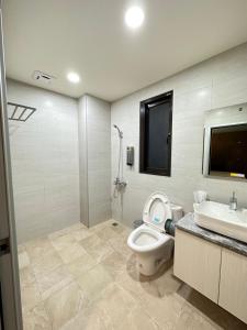a bathroom with a toilet and a sink at 21 Tao Heung Homestay in Jiaoxi