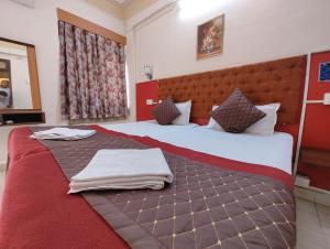 Postel nebo postele na pokoji v ubytování Sanman Hotels