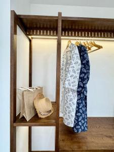 a wooden shelf with a dress and a hat on it at Tropicana Hồ Tràm - Seashell Villa in Ho Tram