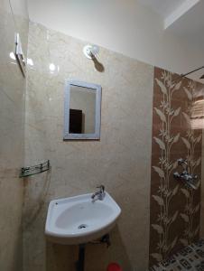 a bathroom with a sink and a mirror at Sanman Hotels in Vasco Da Gama