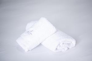 two white towels sitting on top of a table at New Spacious & Stylist Apt in Piraeus +32 photos