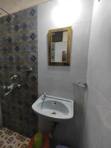 a bathroom with a sink and a mirror at Sanman Hotels in Vasco Da Gama