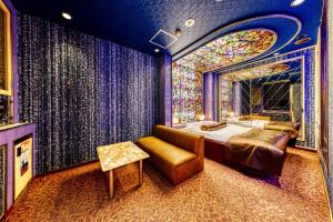a bedroom with a bed and a stained glass window at Hotel Liebhaber -Adult Only in Hirakata