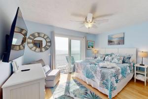 a bedroom with a bed and a view of the ocean at Sea Forever in Kure Beach