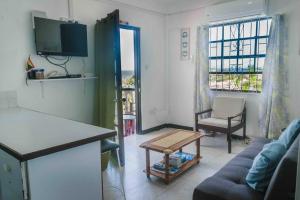 a living room with a couch and a table at Oceans Apartments in DʼArbeau