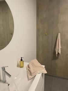 a bathroom sink with a mirror and a towel at Villa Northern Light in Tromsø