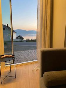 a room with a chair and a window with a view at Villa Northern Light in Tromsø