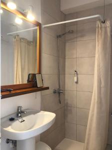 a bathroom with a sink and a shower with a mirror at Nure Mar y Mar in Cala en Blanes