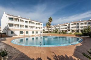 a large swimming pool in front of a building at Villa Calma 450m from the beach in Cala en Blanes