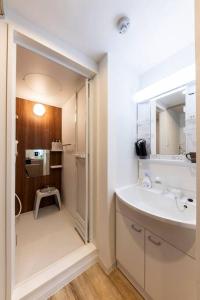 a white bathroom with a sink and a mirror at SENTIMENT 千歳MS105 in Chitose