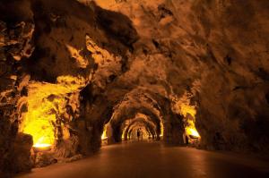 a tunnel in a cave with lights in it at UNA HOTELS Capotaormina in Taormina