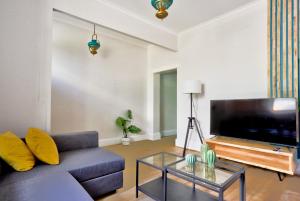 a living room with a couch and a tv at 2 Bedroom House with 2 E-Bikes Included at Centre of Chippendale in Sydney