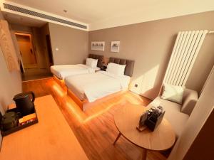 Voodi või voodid majutusasutuse True Go Hotel - Beijing Asian Games Village National Convention Center toas